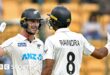 New Zealand batters Will Young and Rachin Ravindra celebrate victory in India