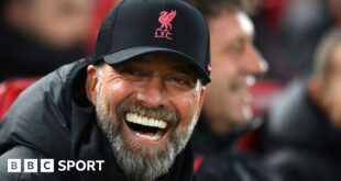 Jurgen Klopp smiling in a Liverpool hat