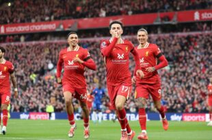 Liverpool beat Chelsea 2-1 to move top of the premier league table