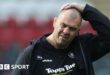 Leicester Tiger's Michael Cheika has his hand on his head while walking off the pitch