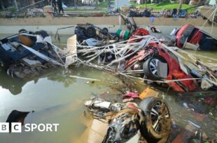 Wreckage of cars remain submerged in the water after flash floods in Valencia.