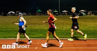 Competitors run through the night in the Sri Chinmoy 24hr Track Race in Battersea Park