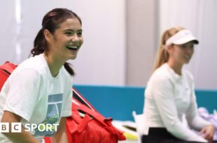 Emma Raducanu laughs during a training session for Great Britain at the Billie Jean King Cup in Malaga