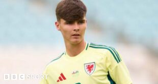 Charlie Crew while playing for Wales in a yellow change strip