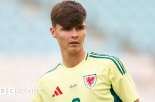 Charlie Crew while playing for Wales in a yellow change strip