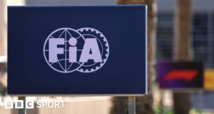 The FIA logo on a board at the side of the track during testing in Bahrain