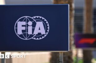 The FIA logo on a board at the side of the track during testing in Bahrain