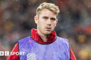 Ollie Cooper warms up with Wales