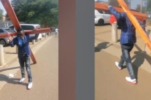 South African Pastor carries large cross while walking to court for his trial over alleged kidnapping, possession of dangerous weapons, and assault