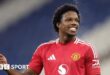 Manchester United defender Tyrell Malacia smiles while playing in the EFL Trophy