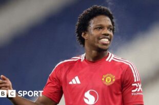 Manchester United defender Tyrell Malacia smiles while playing in the EFL Trophy