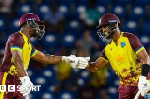 Evin Lewis and Shai Hope bump fists during their partnership of 136 v England