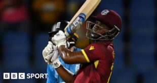 Evin Lewis hits a boundary against England