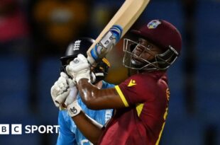 Evin Lewis hits a boundary against England