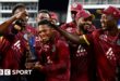 Keacy Carty of the West Indies celebrates his century with Brandon King.