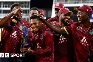 Keacy Carty of the West Indies celebrates his century with Brandon King.