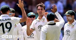 Australia captain Pat Cummins celebrates taking five wickets with his team-mates