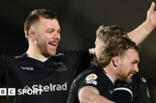 Callum Chick (left) - with his arms out - celebrates with Alex Hearle and Tom Gordon following Newcastle's win over Saracens