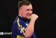 Luke Littler celebrates winning a leg against Ian White in the third round of the PDC World Darts Championship