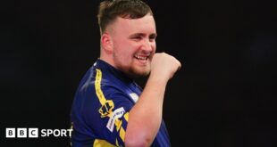 Luke Littler celebrates winning a leg against Ian White in the third round of the PDC World Darts Championship