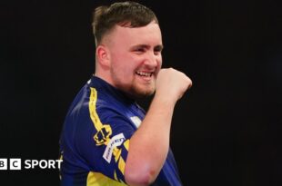 Luke Littler celebrates winning a leg against Ian White in the third round of the PDC World Darts Championship