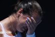 An emotional Jodie Burrage covers her face after beating Leolia Jeanjean in the Australian Open first round