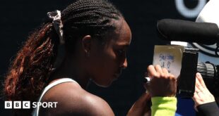 A message reading 'Stay strong LA, thank you firefighters' written on a camera lens by Coco Gauff at the Australian Open