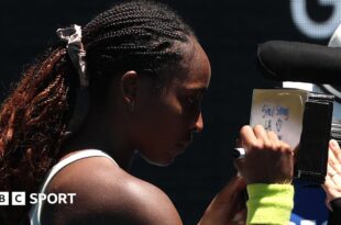 A message reading 'Stay strong LA, thank you firefighters' written on a camera lens by Coco Gauff at the Australian Open