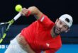 Jacob Fearnley hits a serve against Nick Kyrgios at the Australian Open