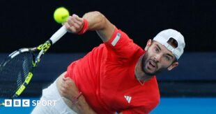 Jacob Fearnley hits a serve against Nick Kyrgios at the Australian Open