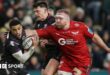 Keelan Giles of Ospreys is challenged by Henry Thomas