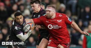 Keelan Giles of Ospreys is challenged by Henry Thomas