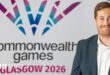 Phil Batty in front of a Commonwealth Games logo