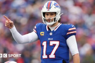 Buffalo Bills quarterback Josh Allen points to his team-mate during their Wildcard Weekend game agains the Denver Broncos