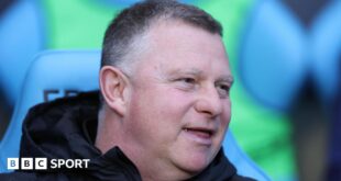 Mark Robins sitting in the dugout during his time as Coventry City boss